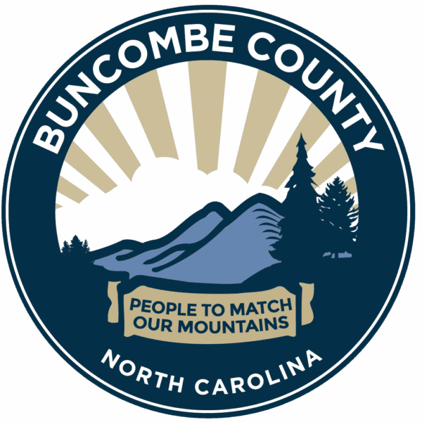 Circular logo for Buncombe County, North Carolina, featuring stylized mountains, trees, and sun rays. A banner reads People to Match Our Mountains below the landscape illustration.