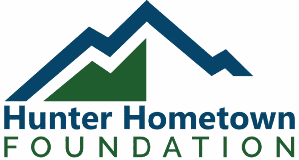 Logo for Hunter Hometown Foundation featuring stylized blue and green mountain peaks above the organization’s name in blue and green text on a white background.